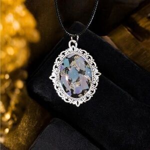 Ornate Silver and Black Necklace with Intricate Pendant